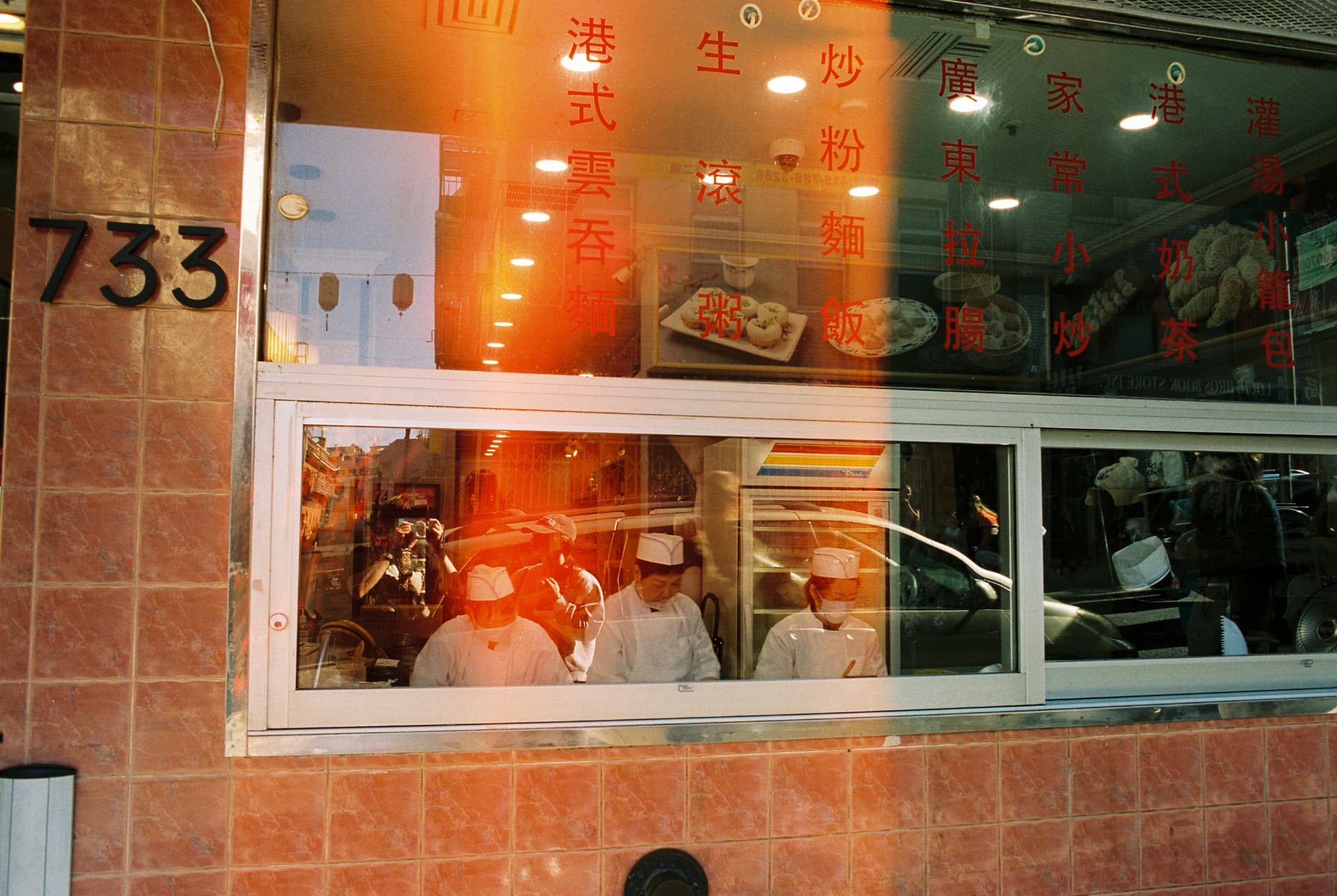 Warm sunlight on a restaurant window with diners inside