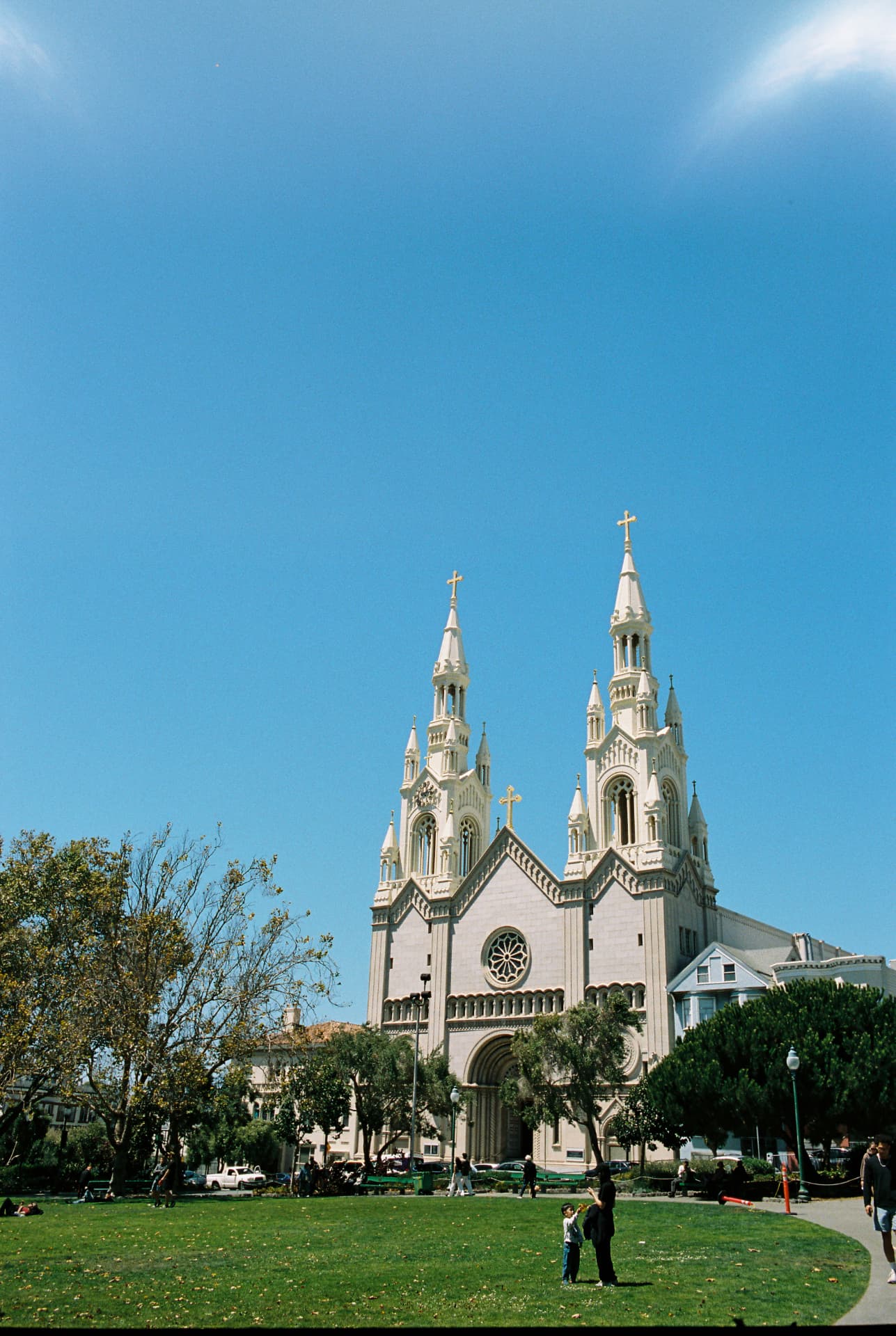 Church facade and twin spires beneath a bright blue sky