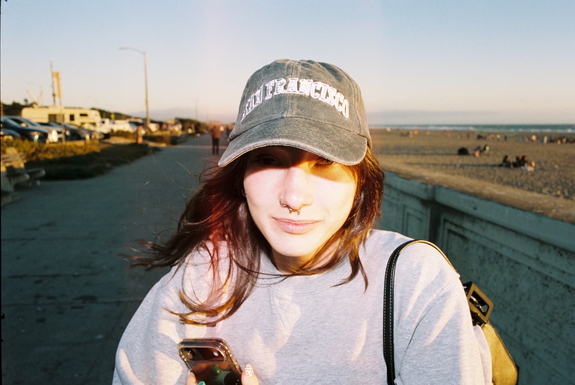 Portrait of a person wearing a cap beside the water in afternoon light